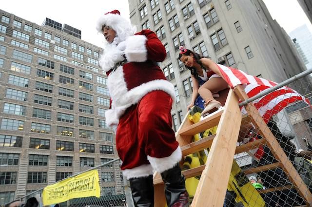 A protester dressed as Santa Claus enters Duarte Square